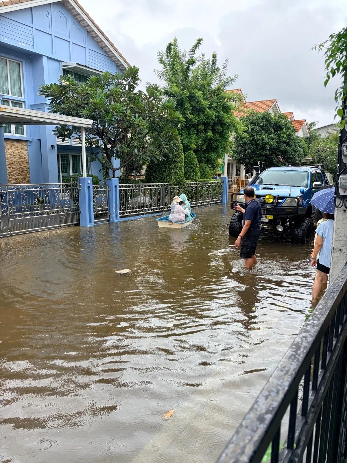 积水中的社区道路,小舟与皮卡停在家门外